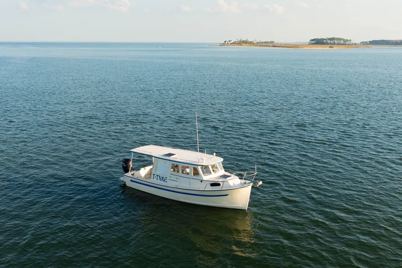 Slide: The Image of Rosborough 246LVS 2000 boat docked at marina, surrounded by other vessels. - 33