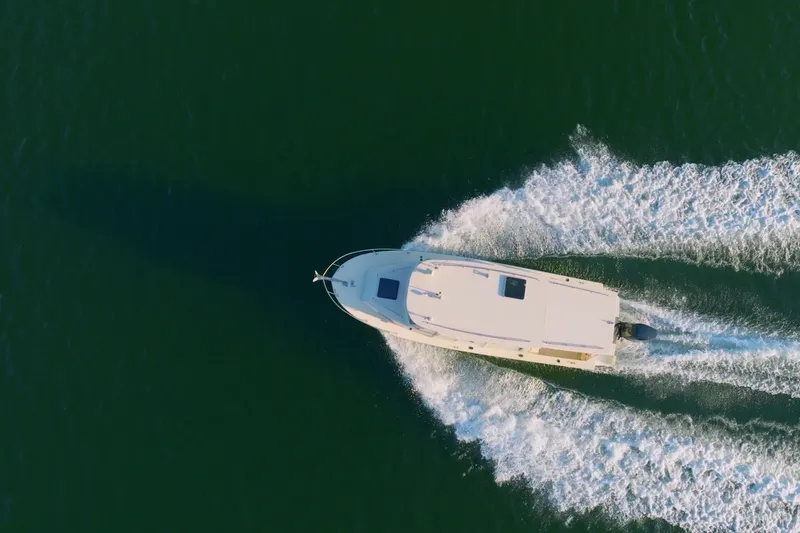 Slide: The Image of 2000 Rosborough 246LVS boat on calm water with distant shoreline. - 35
