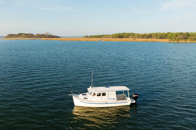 Slide: The Image of Rosborough 246LVS boat cruising on calm waters, scenic landscape in the background, 2000 model. - 37