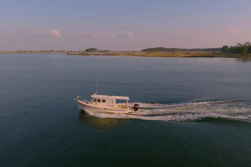 Slide: The Image of 2000 Rosborough 246LVS boat on calm water with scenic background. - 41