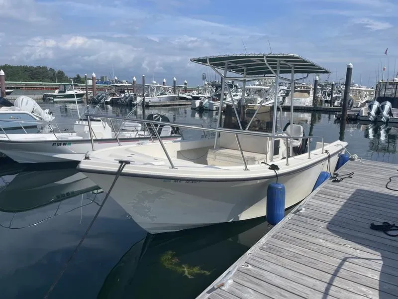 Slide: The Image of 1995 Parker 21 CC boat docked at marina, clear sky, calm water. - 8