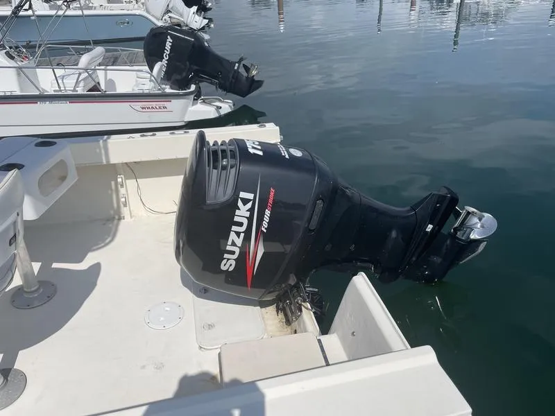 Slide: The Image of 1995 Parker 21 CC boat with Suzuki outboard motor at marina. - 9