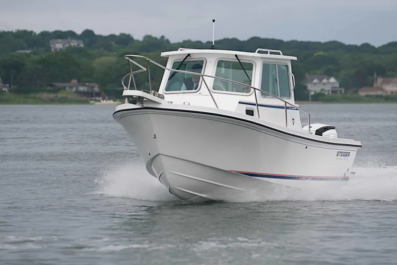 Slide: The Image of 2026 Steiger Craft 21 MIAMI boat cruising on a calm lake with scenic background. - 5