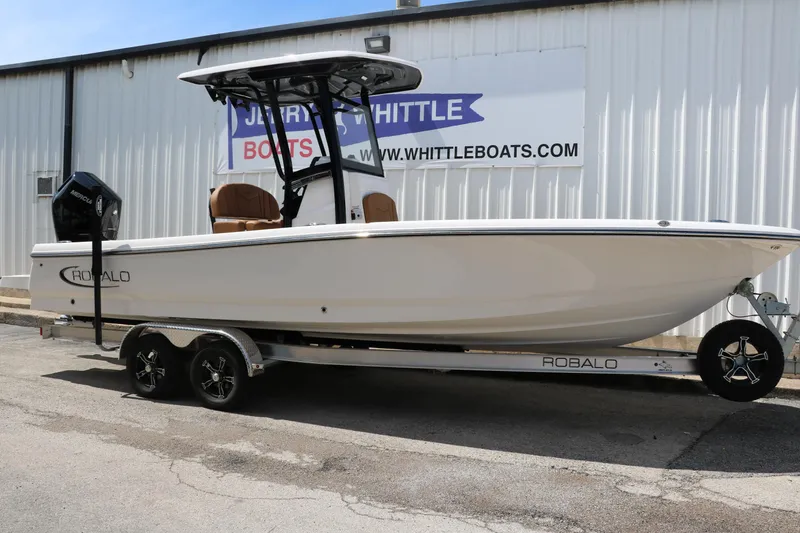 The Image of 2025 Robalo 246 Cayman boat on trailer outside dealership. - 0