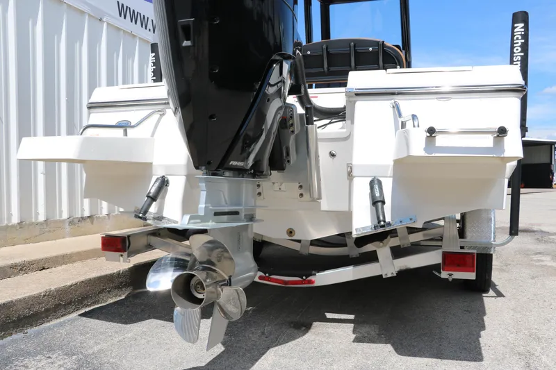 Slide: The Image of 2025 Robalo 246 Cayman boat rear view with outboard motor and trailer. - 11