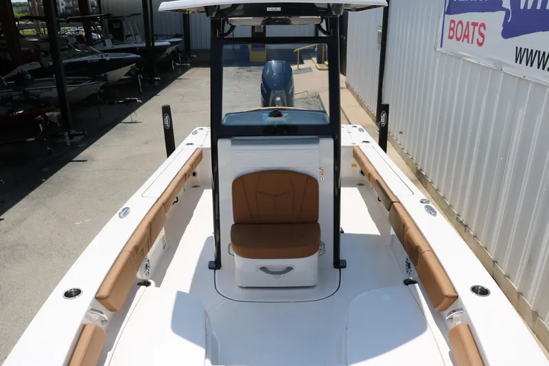 Slide: The Image of 2025 Robalo 246 Cayman boat interior with tan seating and sleek design. - 21