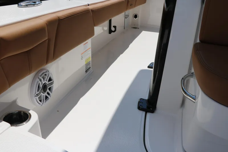 Slide: The Image of 2025 Robalo 246 Cayman boat interior with tan seating and speaker. - 25