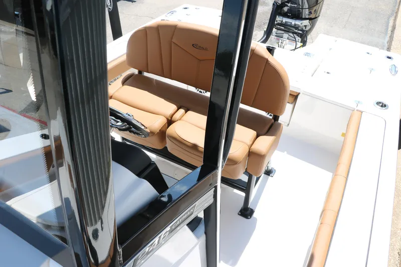 Slide: The Image of 2025 Robalo 246 Cayman boat interior with tan seating and steering console. - 26