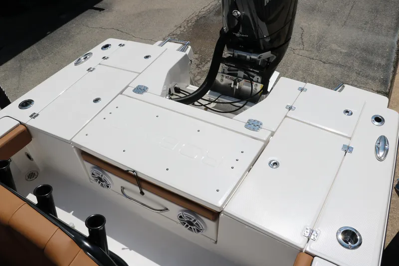 Slide: The Image of 2025 Robalo 246 Cayman boat deck with engine, featuring storage compartments and seating. - 27