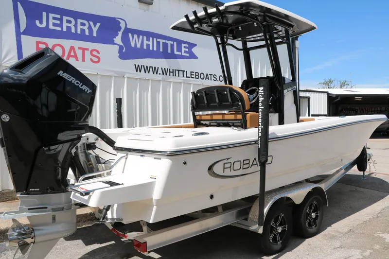 Slide: The Image of 2025 Robalo 246 Cayman boat on trailer at dealership, featuring Mercury engine. - 3