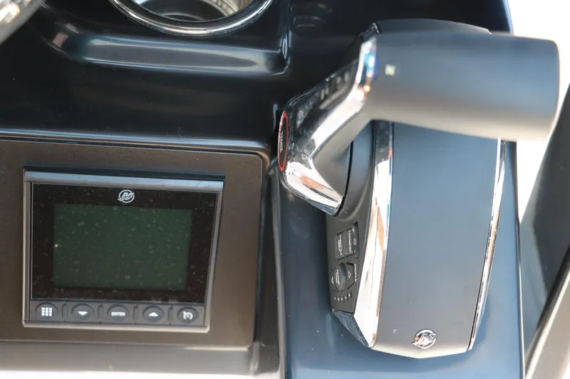 Slide: The Image of Control panel and throttle of 2025 Robalo 246 Cayman boat, featuring modern design elements. - 39