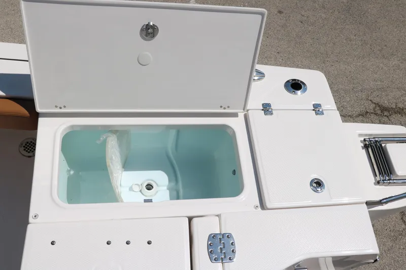 Slide: The Image of 2025 Robalo 246 Cayman boat livewell and storage compartments, open on deck. - 41