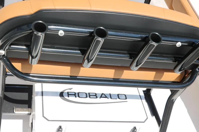 Slide: The Image of 2025 Robalo 246 Cayman boat with rod holders and cushioned seating. - 42