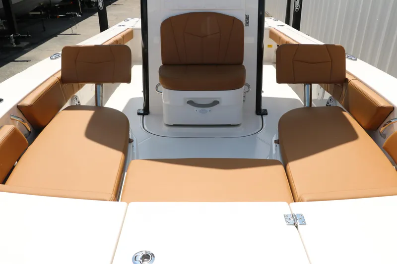 Slide: The Image of 2025 Robalo 246 Cayman boat interior with tan seating and white deck. - 49