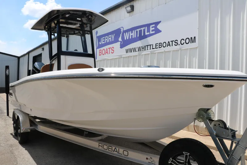Slide: The Image of 2025 Robalo 246 Cayman boat on trailer at Jerry Whittle Boats dealership. - 5