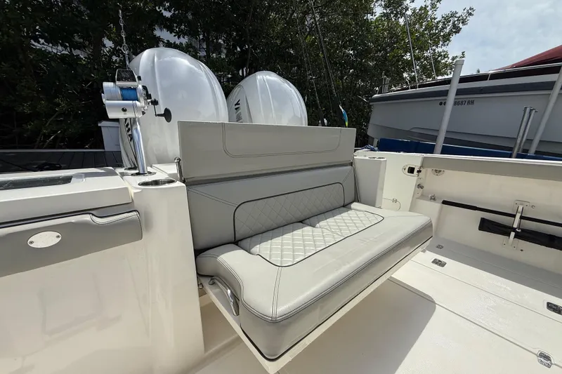 Slide: The Image of Livewell on 2022 Pursuit S 358 Sport boat, open lid, white interior. - 11