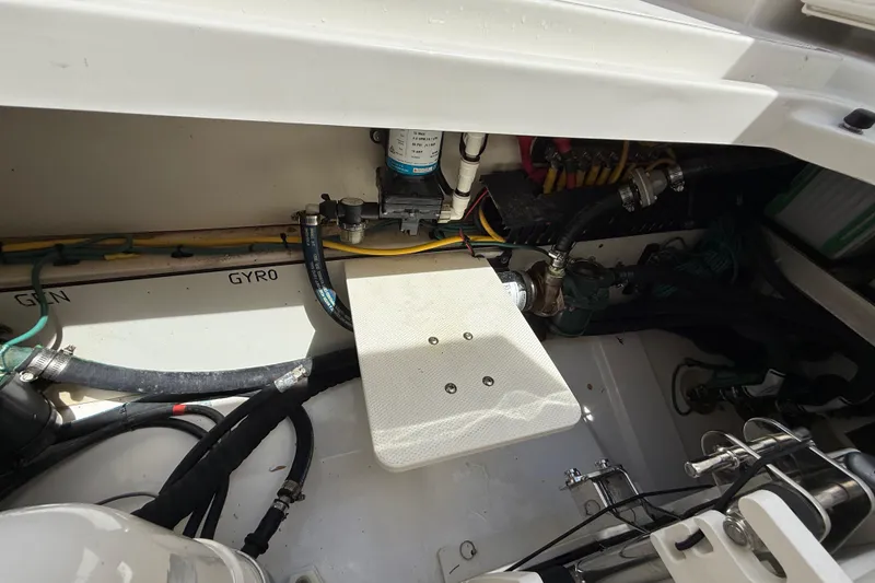 Slide: The Image of 2022 Pursuit S 358 Sport engine compartment with batteries and cables. - 14