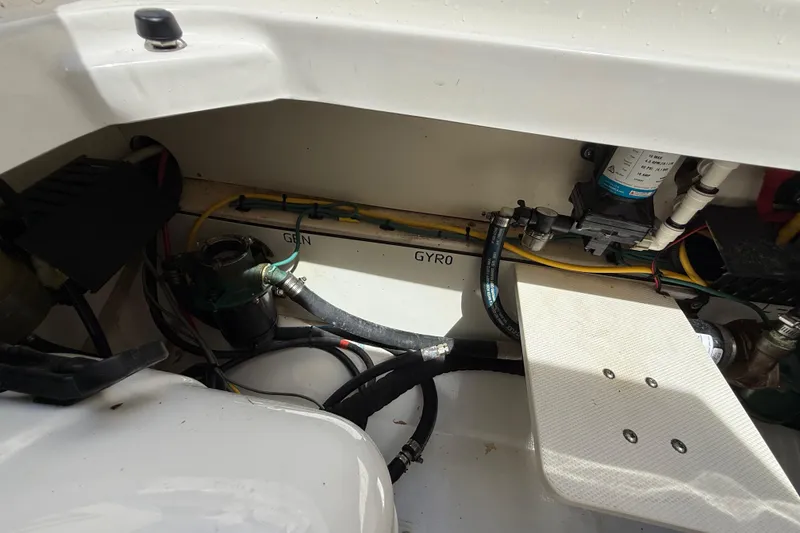 Slide: The Image of Engine compartment of a 2022 Pursuit S 358 Sport boat, showing hoses and components. - 15