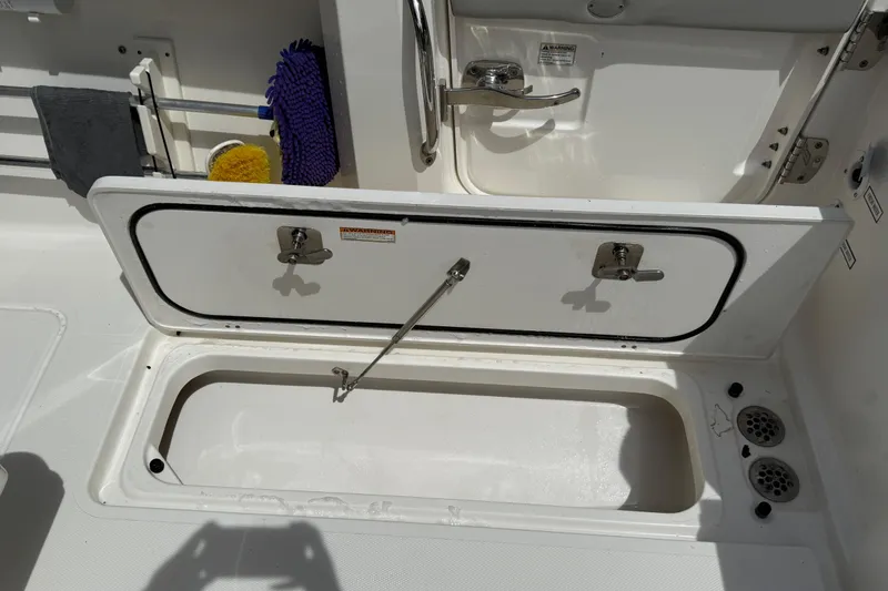 Slide: The Image of Engine compartment of a 2022 Pursuit S 358 Sport boat, showing hoses and components. - 16