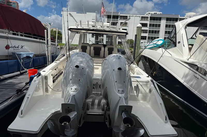 Slide: The Image of 2022 Pursuit S 358 Sport boat with Yamaha outboard engines docked at a marina. - 2