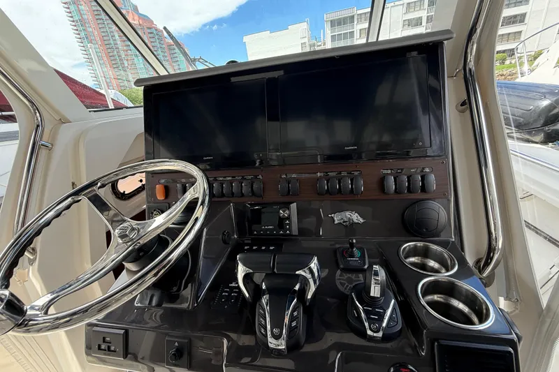 Slide: The Image of Interior cockpit of 2022 Pursuit S 358 Sport boat with modern controls and steering wheel. - 22