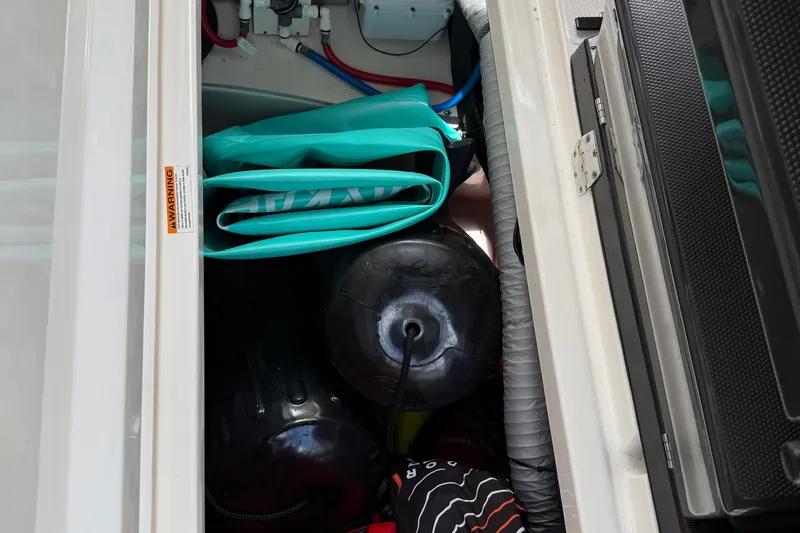 Slide: The Image of 2022 Pursuit S 358 Sport boat engine compartment with water heater and wiring. - 28