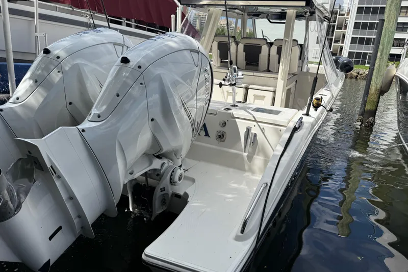 Slide: The Image of 2022 Pursuit S 358 Sport boat docked with dual outboard engines. - 3