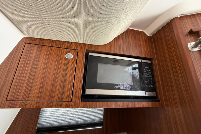 Slide: The Image of 2022 Pursuit S 358 Sport cabin interior with wood finish and modern amenities. - 31