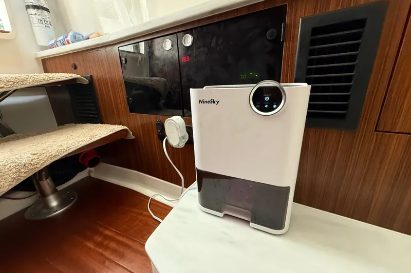 Slide: The Image of 2022 Pursuit S 358 Sport interior with microwave and wooden cabinetry. - 32