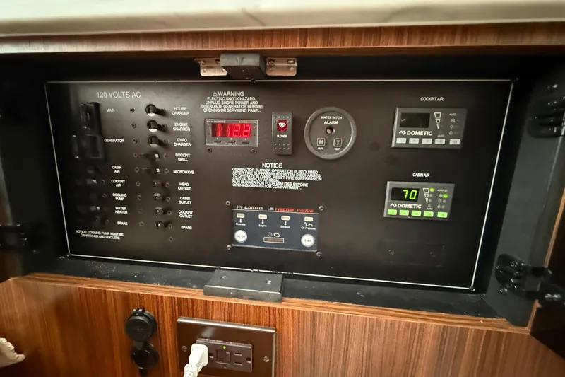 Slide: The Image of Air purifier in 2022 Pursuit S 358 Sport boat interior, near wooden panel and carpeted steps. - 33
