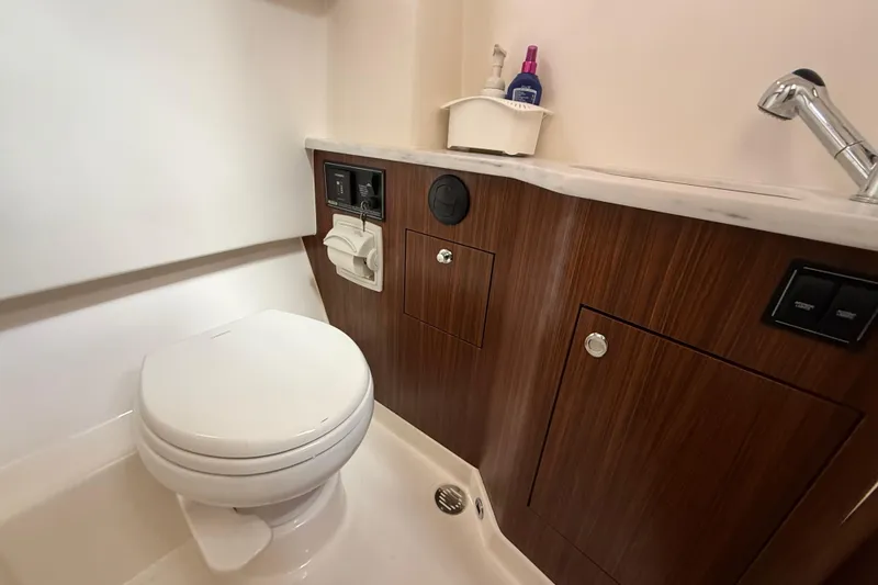 Slide: The Image of 2022 Pursuit S 358 Sport boat bathroom with window, mirror, and toiletries. - 35