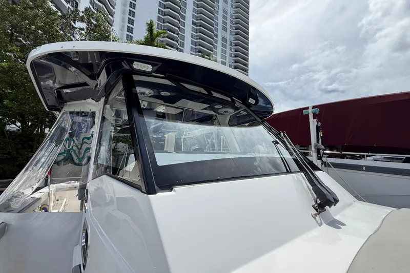 Slide: The Image of 2022 Pursuit S 358 Sport boat with spacious seating and table on deck. - 39