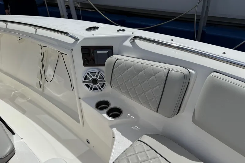 Slide: The Image of 2022 Pursuit S 358 Sport boat with sleek design, docked near high-rise buildings. - 40