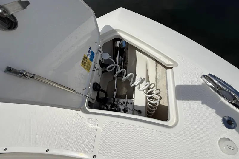 Slide: The Image of 2022 Pursuit S 358 Sport boat with seating and table, docked near other vessels. - 44