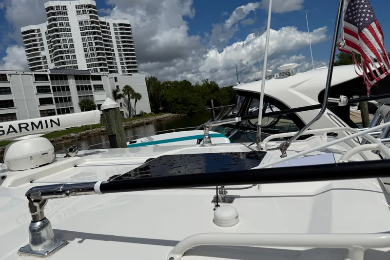 Slide: The Image of 2022 Pursuit S 358 Sport boat anchor compartment with open hatch and coiled rope. - 45
