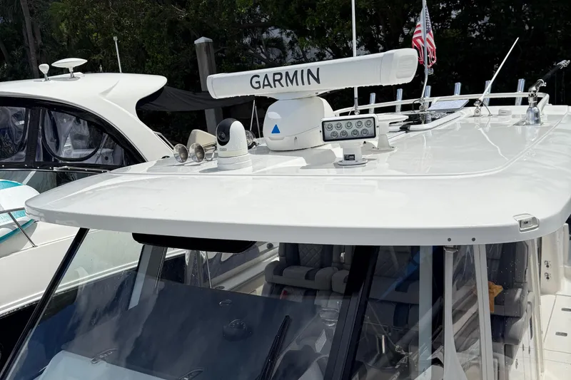 Slide: The Image of 2022 Pursuit S 358 Sport boat with Garmin equipment docked near trees. - 47