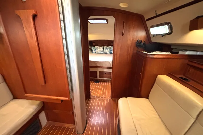 Slide: The Image of Interior of 2001 Island Packet 380 sailboat with wood finish and cozy seating area. - 10