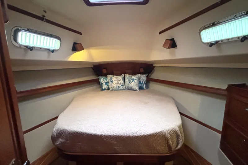 Slide: The Image of Cozy cabin interior of 2001 Island Packet 380 sailboat with decorative pillows. - 11