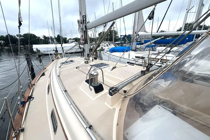 Slide: The Image of 2001 Island Packet 380 sailboat deck view at marina, showcasing rigging and equipment. - 18