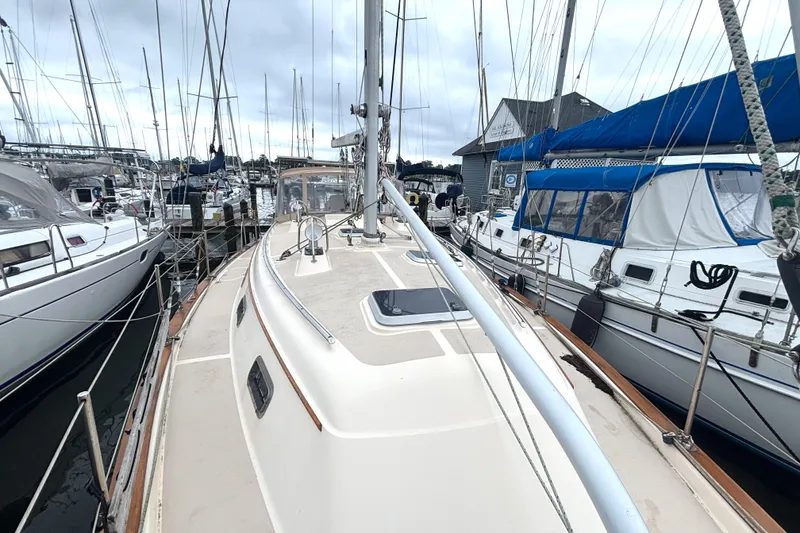 Slide: The Image of 2001 Island Packet 380 sailboat docked among other boats in a marina. - 19