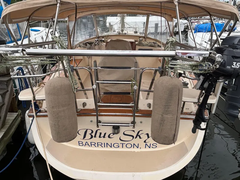 Slide: The Image of Island Packet 380 sailboat, 2001 model, named "Blue Sky," docked with protective fenders. - 2