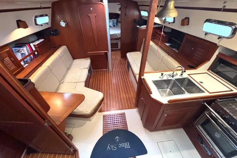 Slide: The Image of Interior of 2001 Island Packet 380 sailboat with wood finish and cozy seating area. - 5