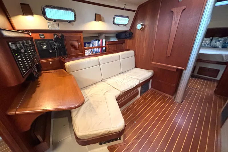 Slide: The Image of Interior of 2001 Island Packet 380 sailboat with cozy seating and wooden finishes. - 7