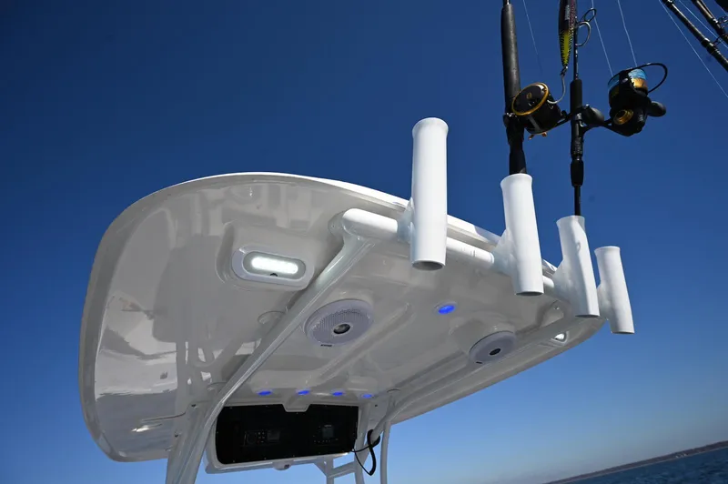 Slide: The Image of 2026 Steiger Craft 255 Tournament boat with fishing rod holders and blue sky background. - 7
