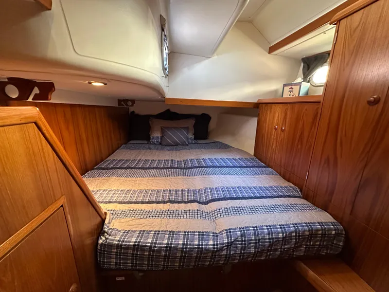 Slide: The Image of Cozy cabin interior of 2000 Jeanneau Sun Odyssey 45.2 with wood paneling and comfortable bedding. - 10