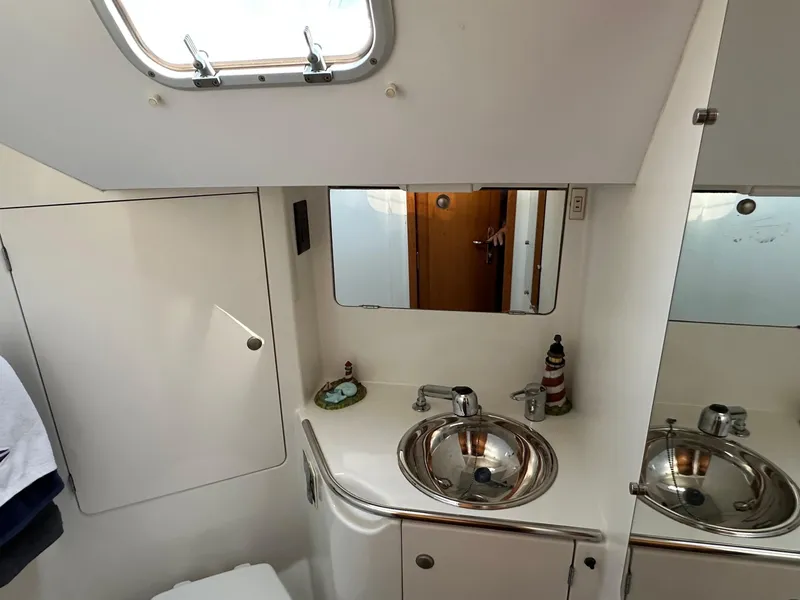 Slide: The Image of Bathroom interior of 2000 Jeanneau Sun Odyssey 45.2 yacht, featuring sink and mirror. - 12