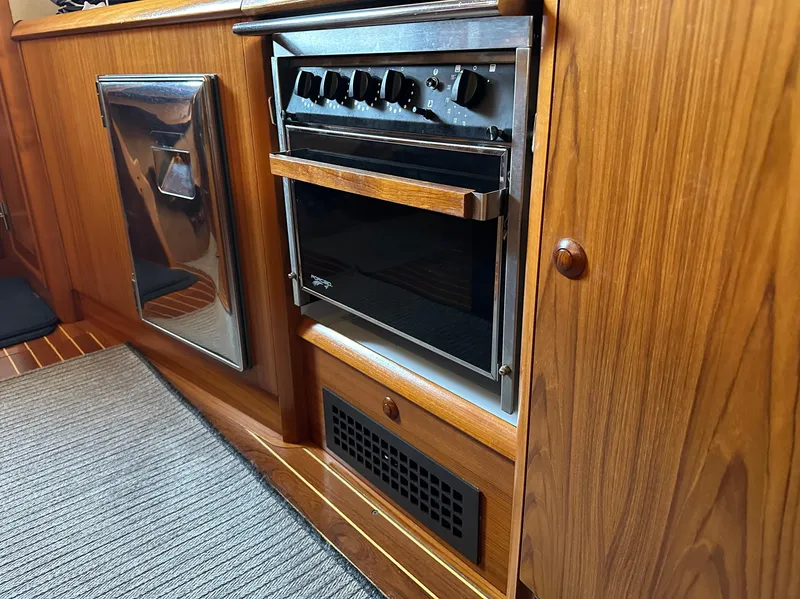 Slide: The Image of Wooden yacht kitchen with oven, Jeanneau Sun Odyssey 45.2, 2000 model. - 16