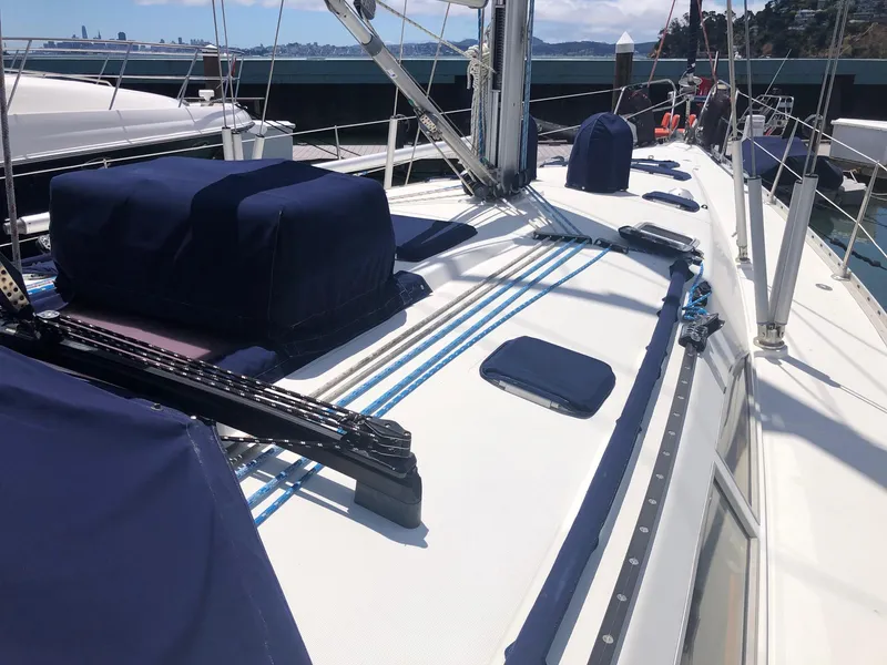Slide: The Image of Deck view of 2000 Jeanneau Sun Odyssey 45.2 sailboat, featuring blue covers and rigging. - 21
