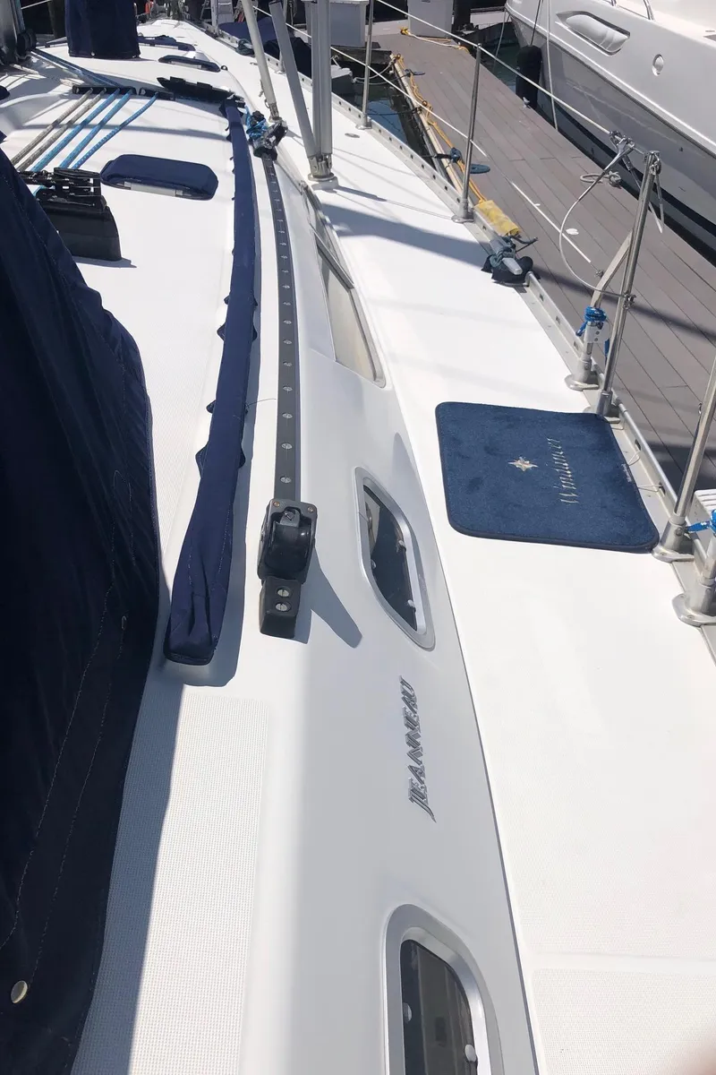 Slide: The Image of Deck view of a 2000 Jeanneau Sun Odyssey 45.2 sailboat, showcasing sleek design and fittings. - 23