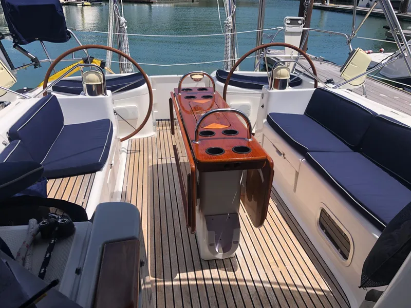 Slide: The Image of Jeanneau Sun Odyssey 45.2 cockpit, 2000 model, featuring dual steering wheels and teak flooring. - 28